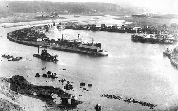 Panormica de la Drsena de San Juan de Nieva con las rocas que dificultaban la entrada a Puerto, y la draga trabajando en el canal de entrada. Esta drsena se modernizar a partir del auge del trfico de carbn, a finales del siglo XIX